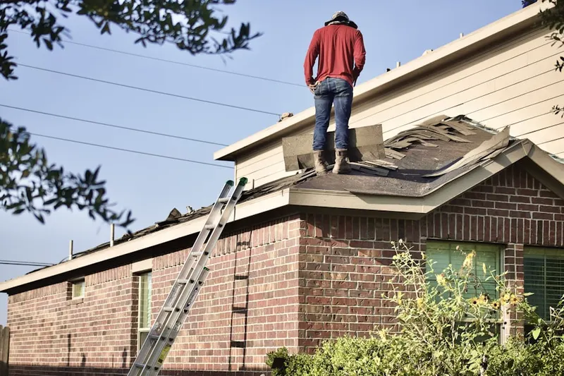 Professional roofer working on a residential roof in Northwood Hills